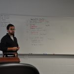 Man in front of white board